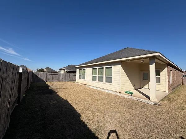 a view of a house with a backyard