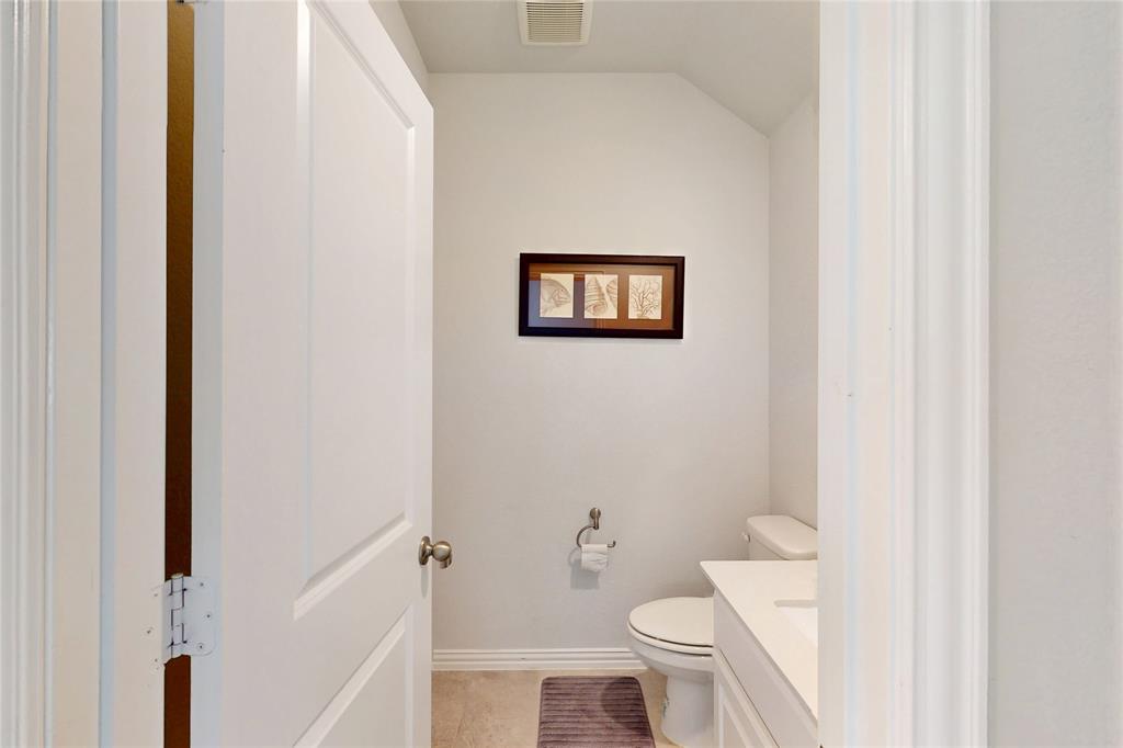 1997 Kieva Place Allen, TX 75013 - Photo 35 of 40 Half bath featuring vanity, lofted ceiling, and light tile patterned floors