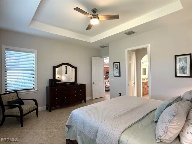 a spacious bathroom with a granite countertop sink and a large mirror