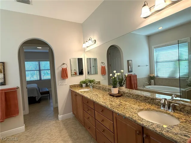 a bathroom with a tub sink and shower