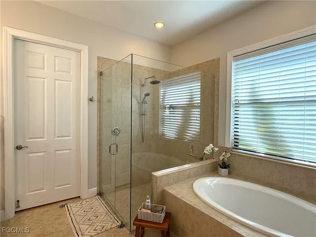 a white toilet sitting next to a white wall