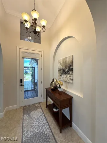a living room with furniture and a painting on the wall