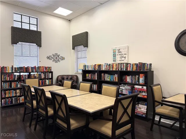 a room with pool table and windows