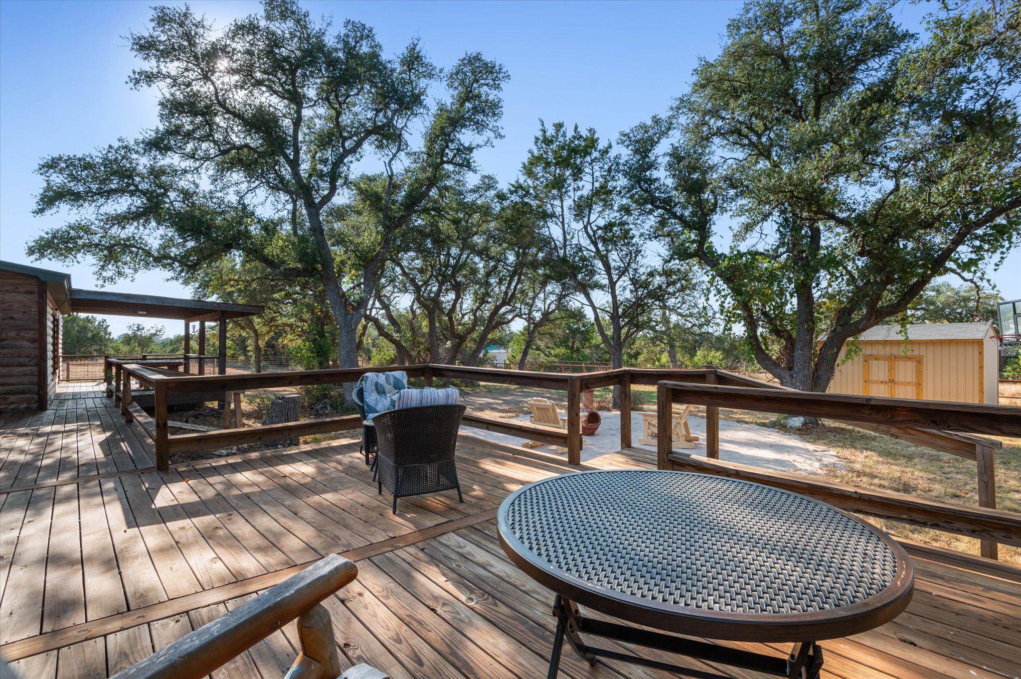 215 Go Away Road Blanco, TX 78606 - Photo 23 of 30 Backyard patio deck goes the whole length of the back of the home. Spacious back deck and outdoor seating area for relaxing, entertaining, or enjoying starry Hill Country nights. Go Away Road in name only — once you’re here, you’ll want to stay.
