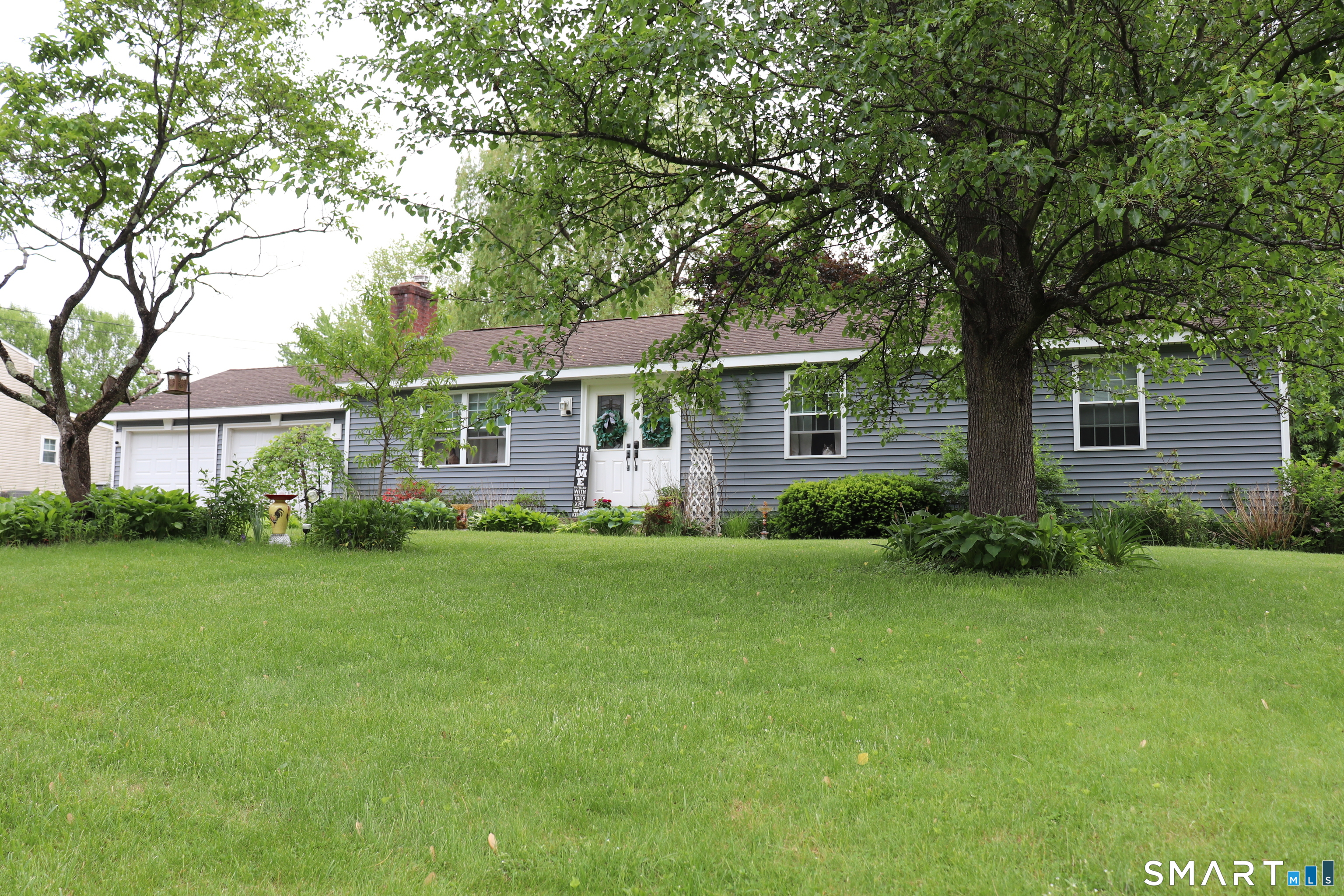 308 Abbe Road Enfield, CT 06082 - Photo 2 of 33 a front view of a house with a garden