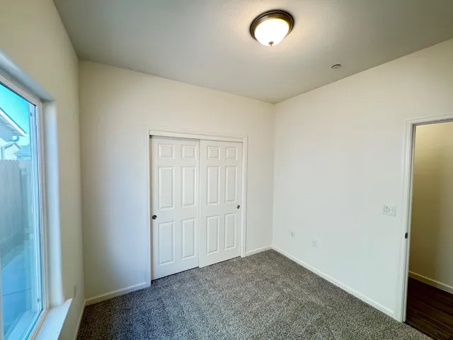 a bathroom with a granite countertop sink a toilet and shower
