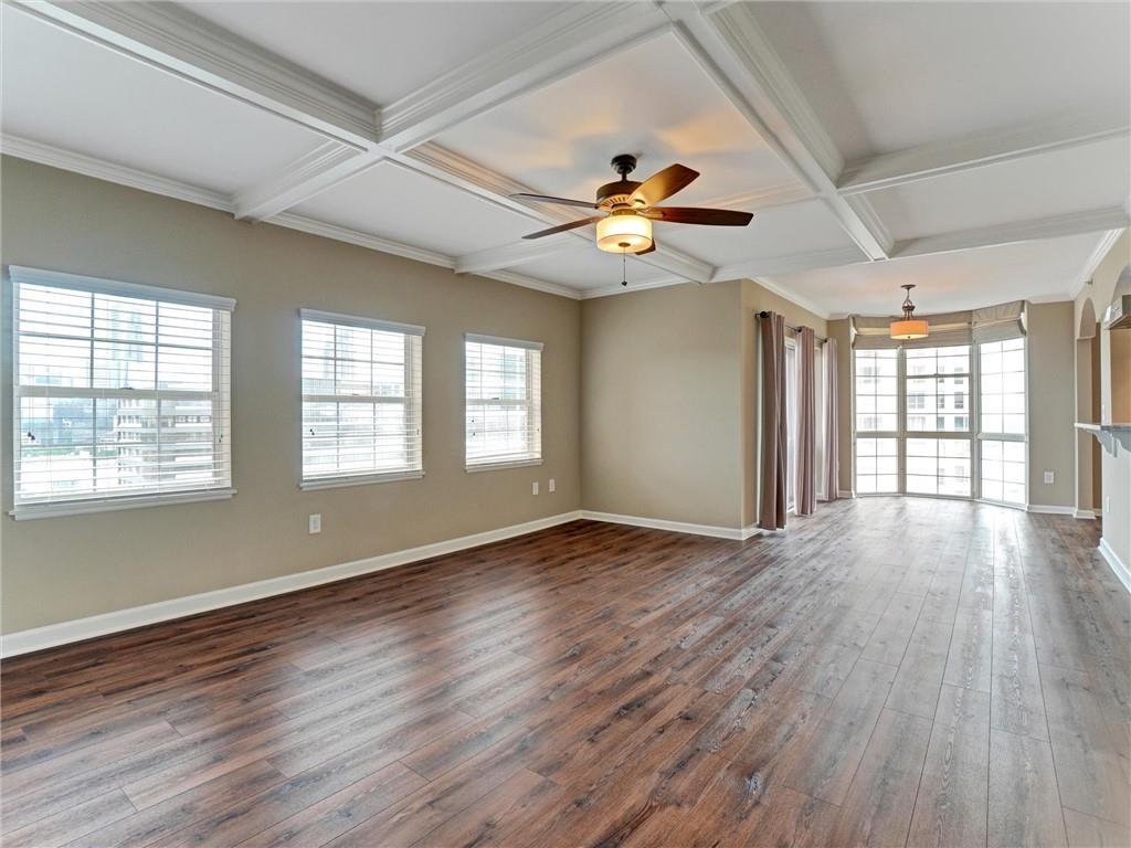 3435 Kingsboro Road Northeast, Unit 1601 Atlanta, GA 30326 - Photo 13 of 54 a view of an empty room with wooden floor and a window