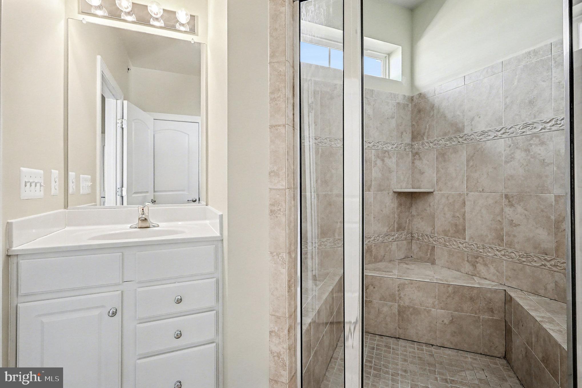 2228 Merseyside Drive Woodbridge, VA 22191 - Photo 15 of 24 a bathroom with a shower sink and mirror