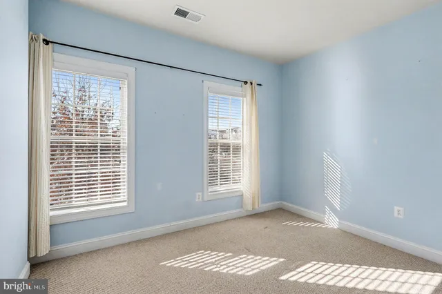 a view of an empty room and closet area