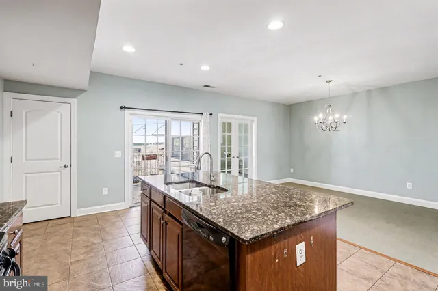 a kitchen with center island table and chairs