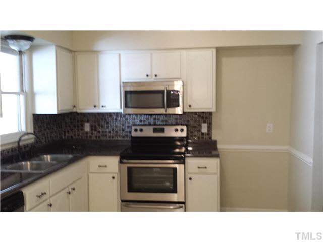 5586 Hamstead Crossing Raleigh, NC 27612 - Photo 3 of 21 a kitchen with a stove and a microwave