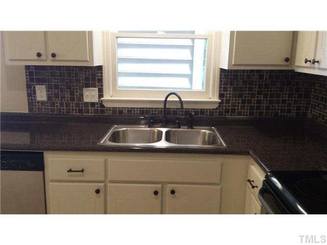 5586 Hamstead Crossing Raleigh, NC 27612 - Photo 5 of 21 a kitchen with a sink and cabinets