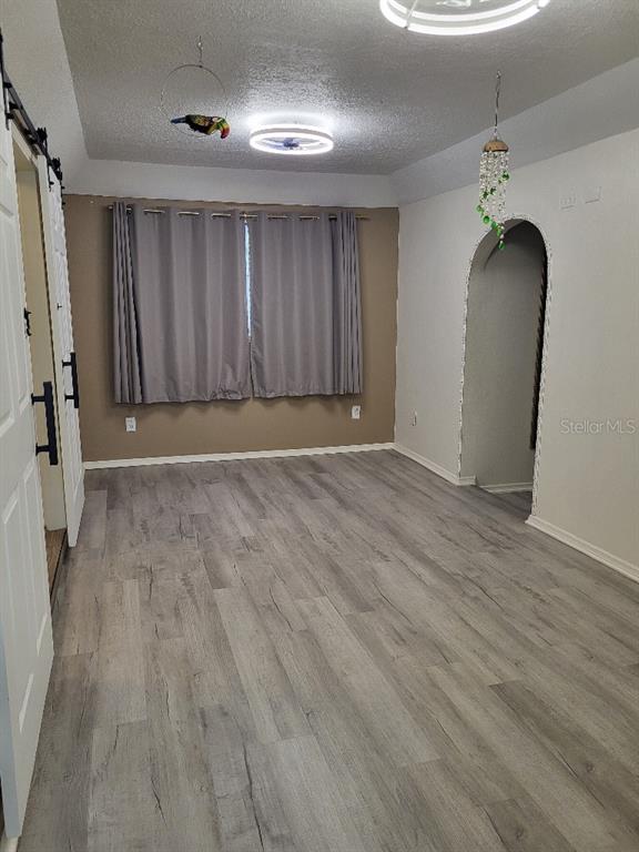 995 Emerald Drive Mount Dora, FL 32757 - Photo 12 of 49 wooden floor in an empty room with a window