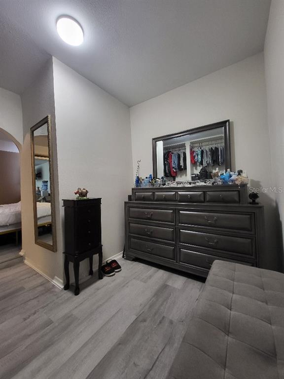 995 Emerald Drive Mount Dora, FL 32757 - Photo 18 of 33 a bed room with furniture and wooden floor