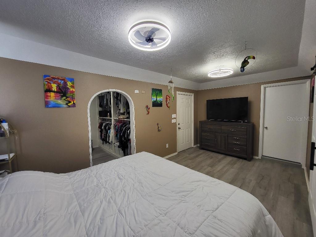 995 Emerald Drive Mount Dora, FL 32757 - Photo 23 of 33 a bedroom with a bed and a flat screen tv