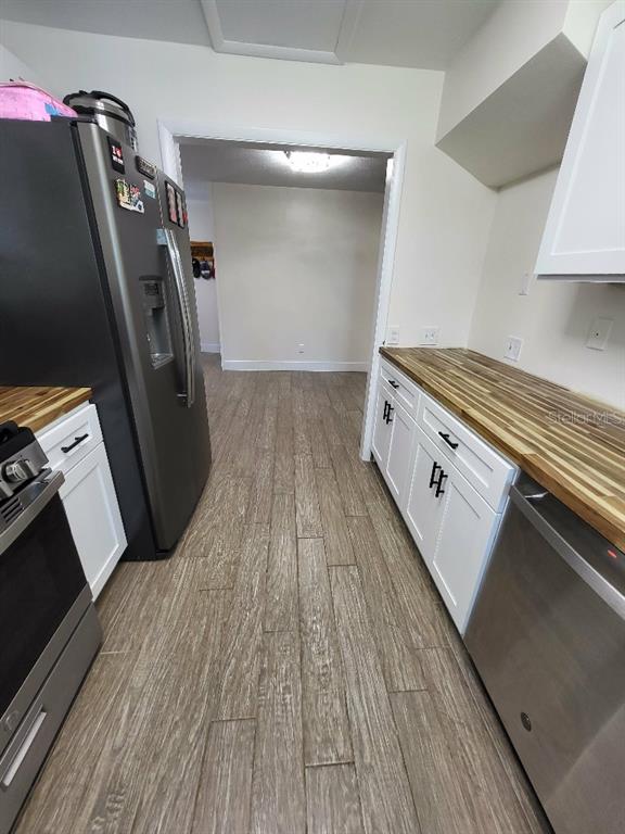 995 Emerald Drive Mount Dora, FL 32757 - Photo 33 of 33 a kitchen with wooden floors and a sink