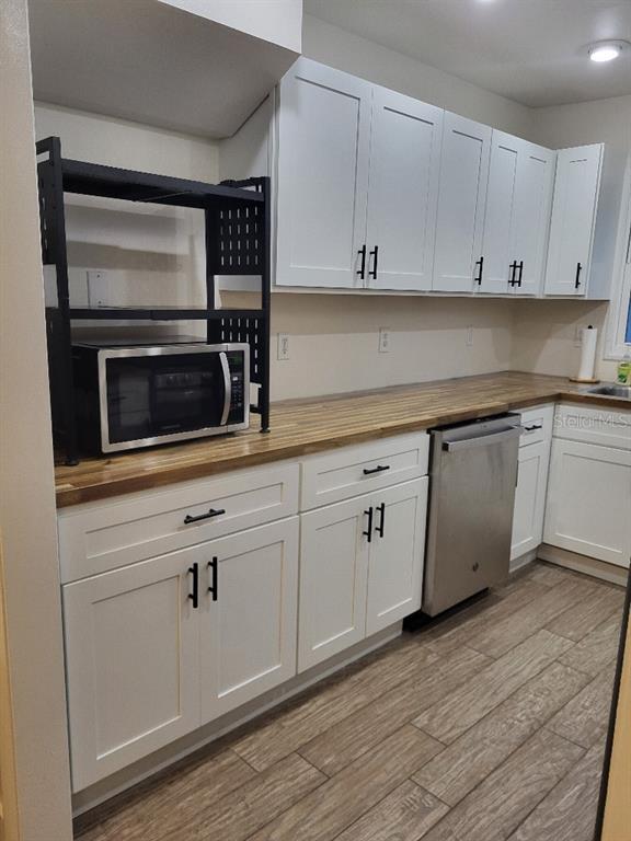 995 Emerald Drive Mount Dora, FL 32757 - Photo 34 of 49 a kitchen with white cabinets stainless steel appliances and sink