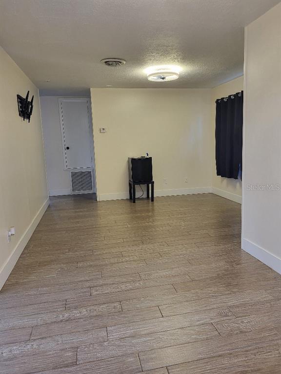 995 Emerald Drive Mount Dora, FL 32757 - Photo 36 of 49 a view of an empty room with wooden floor