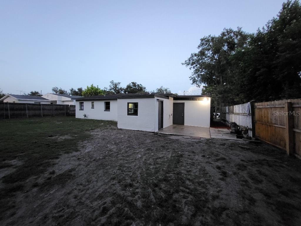 995 Emerald Drive Mount Dora, FL 32757 - Photo 7 of 33 a view of a backyard with plants and large tree