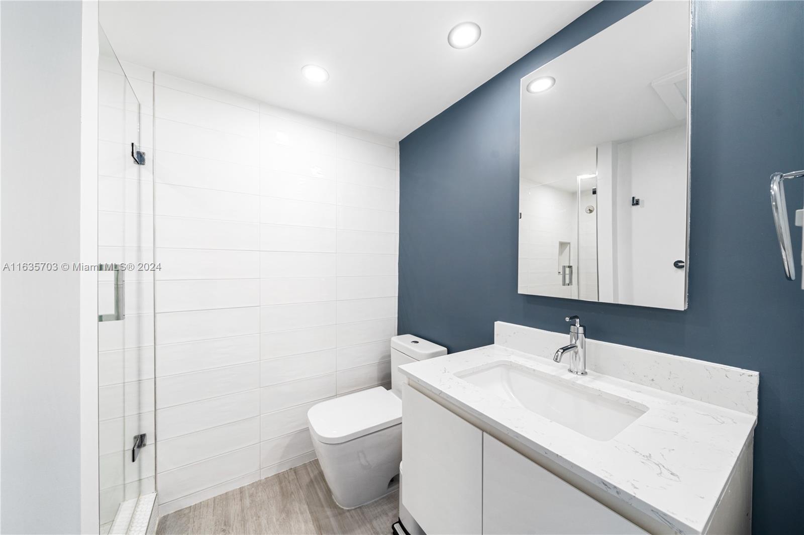 5600 Condominium Miami Beach, FL 33140 - Photo 15 of 27 a bathroom with a sink and a mirror