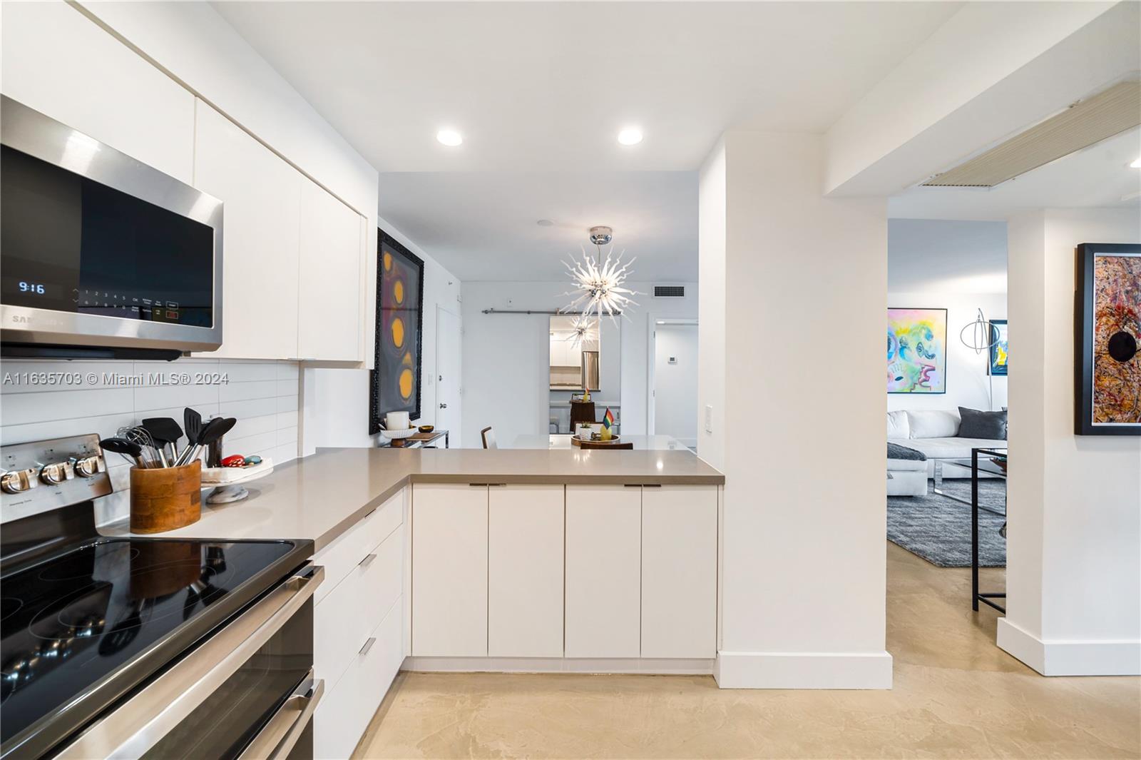 5600 Condominium Miami Beach, FL 33140 - Photo 17 of 27 a kitchen with stainless steel appliances a sink stove and cabinets