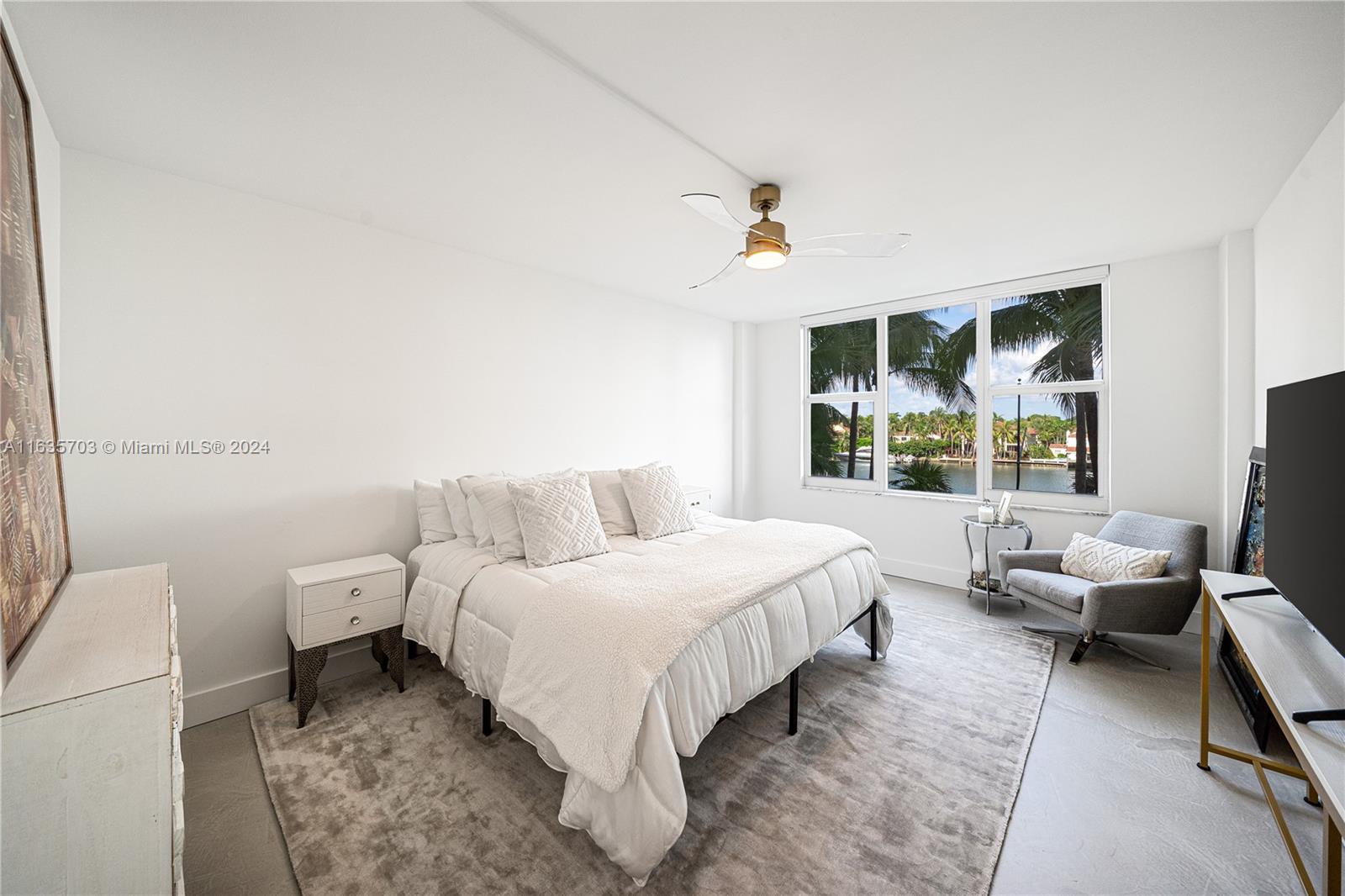 5600 Condominium Miami Beach, FL 33140 - Photo 19 of 27 a bedroom with a bed and glass window