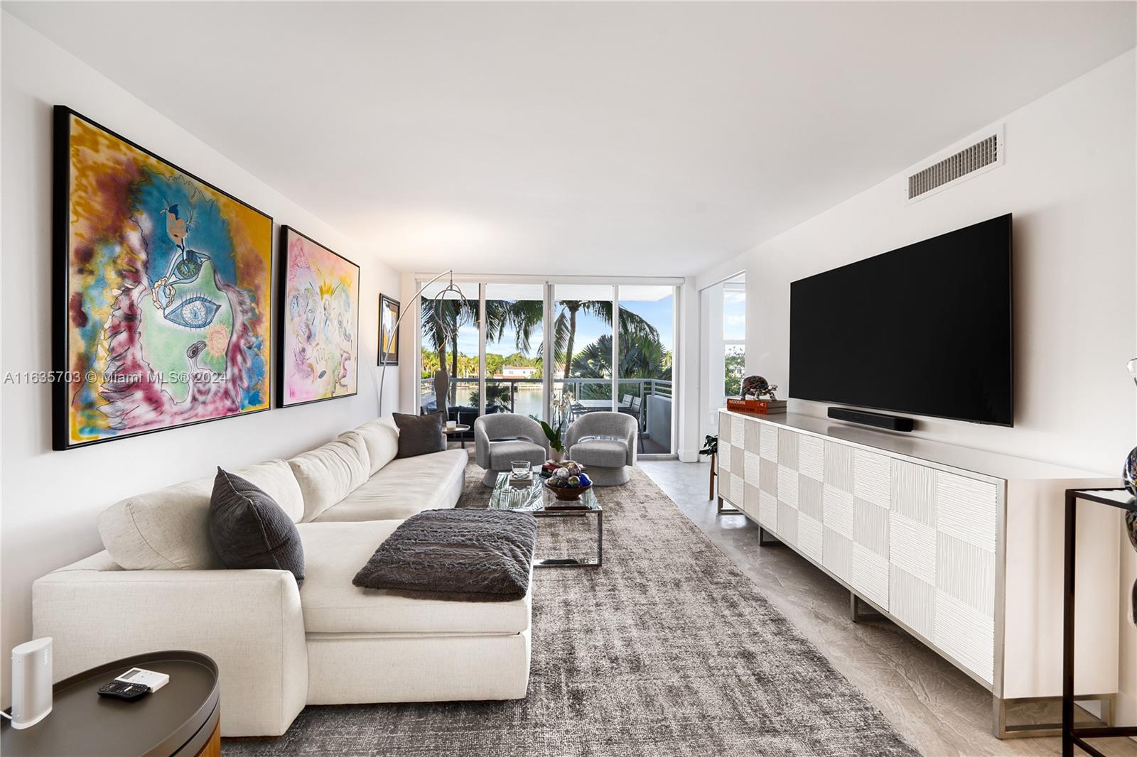 5600 Condominium Miami Beach, FL 33140 - Photo 7 of 27 a living room with furniture and a flat screen tv