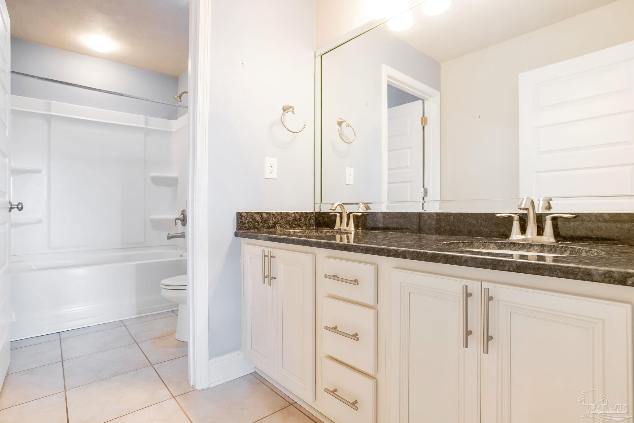 8016 Woodbrook Road Pensacola, FL 32526 - Photo 29 of 52 a bathroom with a granite countertop sink and a mirror