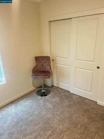 a room with a chair and painted walls