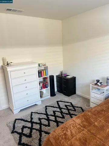 a bedroom with a bed and cabinets