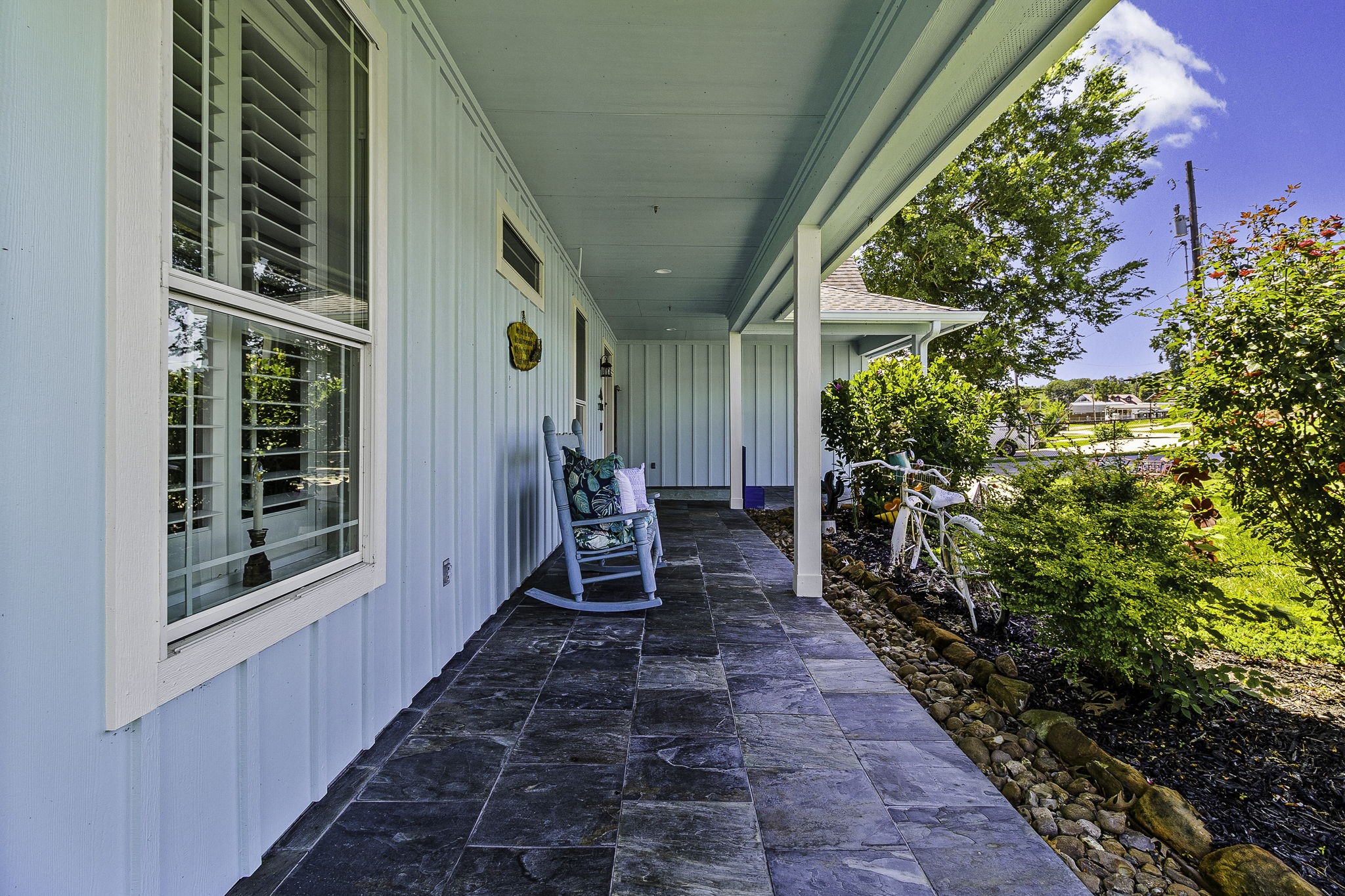 151 Key Largo Loop Point Blank, TX 77364 - Photo 5 of 49 Beautiful, covered porch with slate tile flooring, plantation shutters, and charming curb appeal.