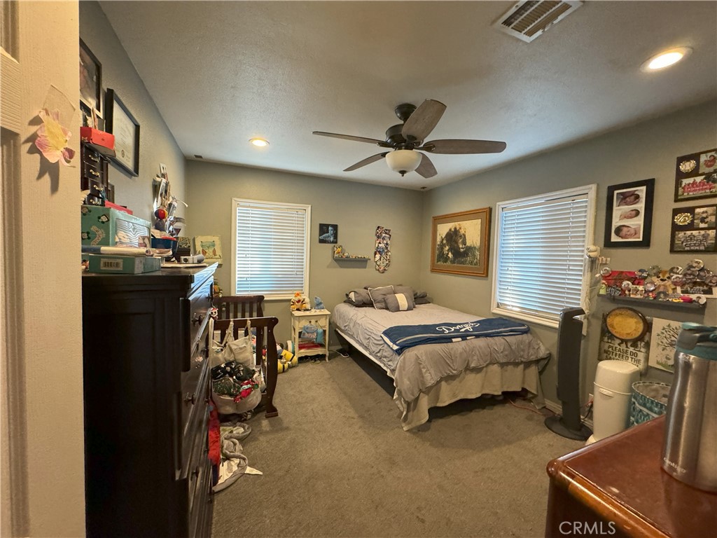 8429 Sheffield Road San Gabriel, CA 91775 - Photo 14 of 19 a bedroom with bed and a chandelier