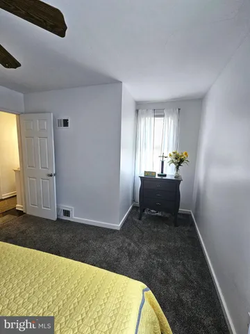 a view of a livingroom with wooden floor and a window