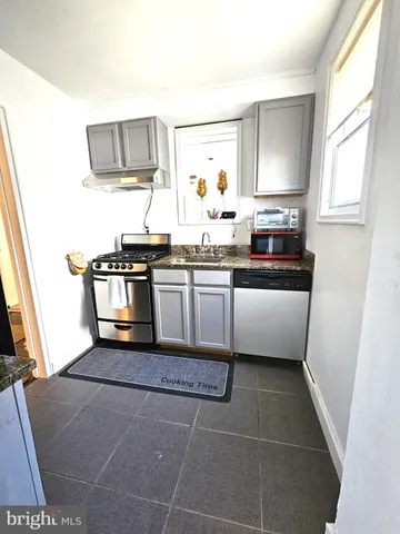 a kitchen with stainless steel appliances a sink and a stove