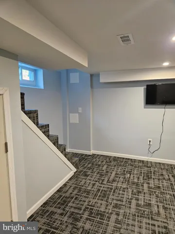 a living room with a couch and a rug