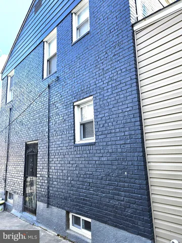 a view of a white house with a large window