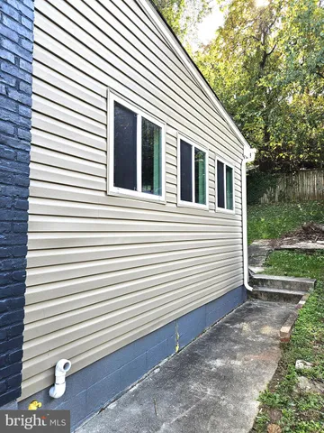 a view of a yard with a house and a large tree