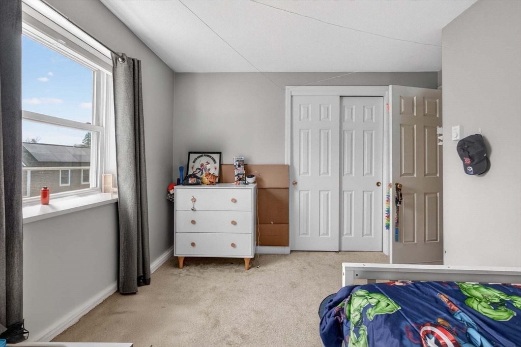 588 Main Street, Unit 3D Stoneham, MA 02180 - Photo 12 of 22 a bed room with a bed and a window