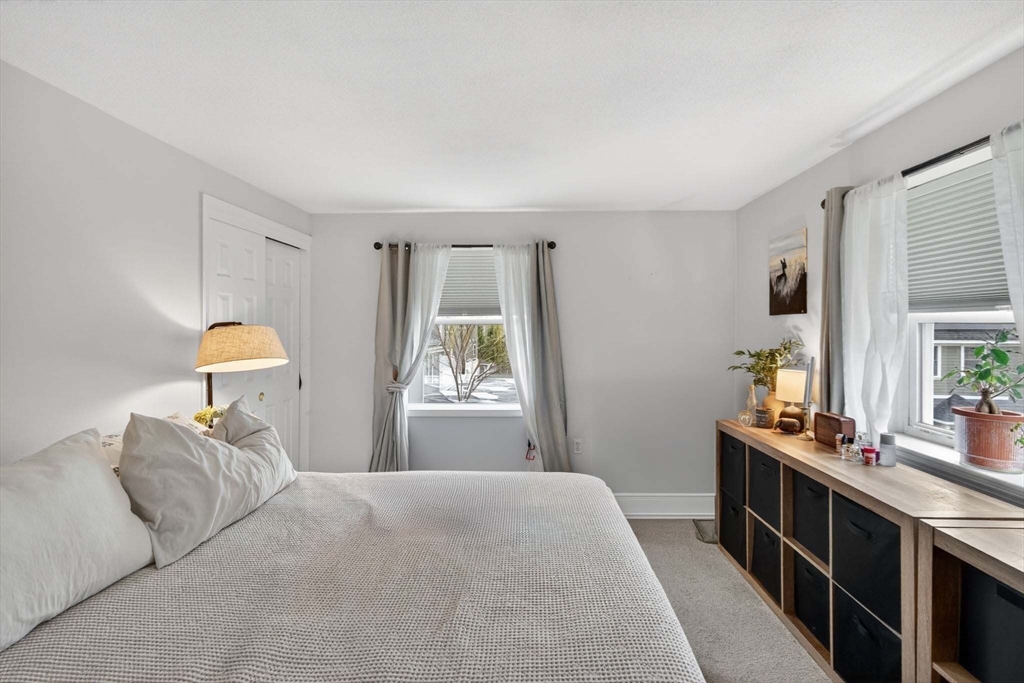 588 Main Street, Unit 3D Stoneham, MA 02180 - Photo 15 of 22 a bedroom with a bed and a large window