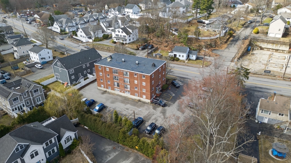 588 Main Street, Unit 3D Stoneham, MA 02180 - Photo 21 of 22 an aerial view of a house with a yard and large trees