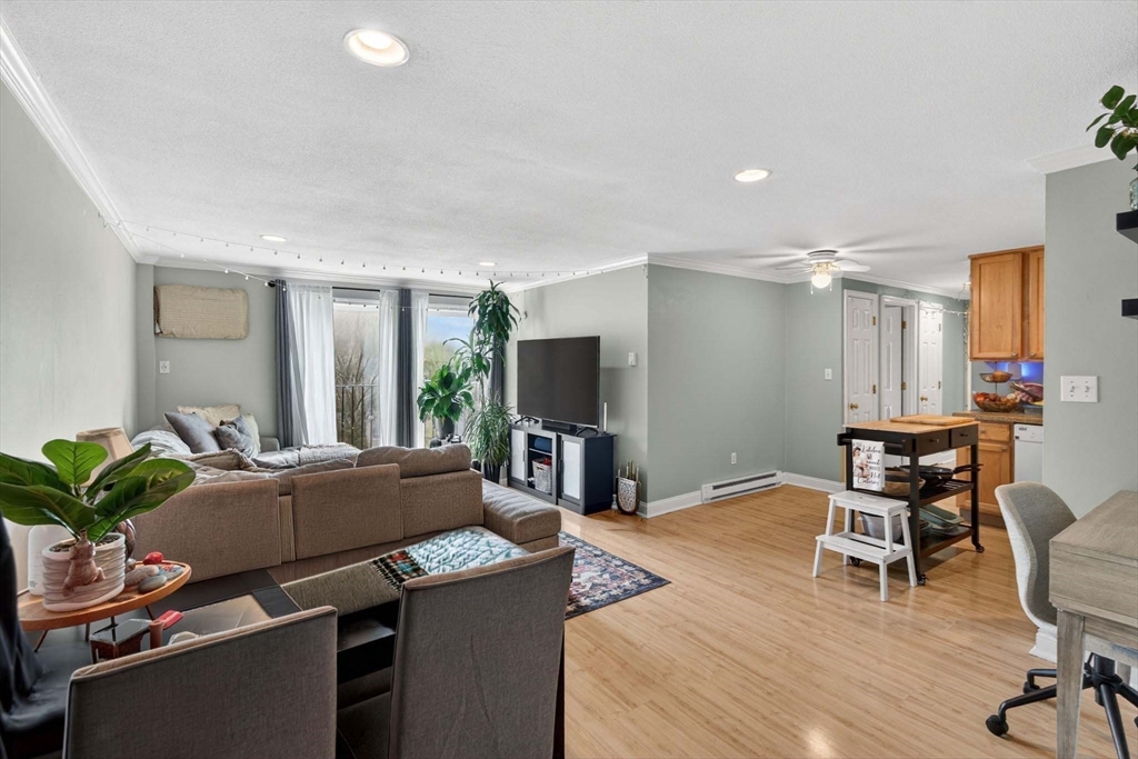 588 Main Street, Unit 3D Stoneham, MA 02180 - Photo 10 of 22 a living room with furniture and a flat screen tv