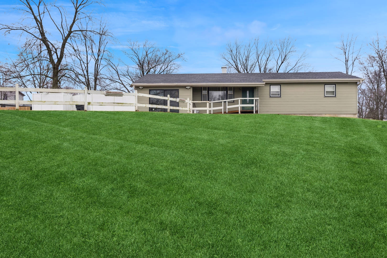 a front view of house with yard and green space