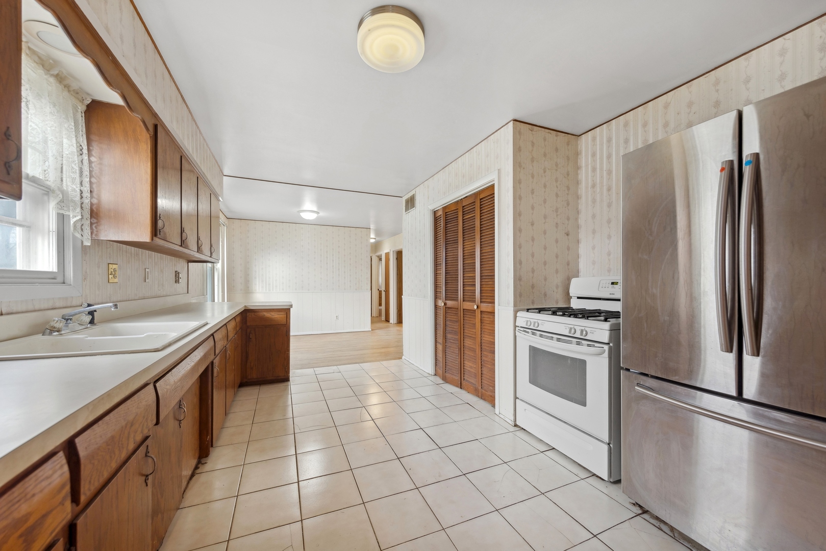 213 South Anderson Road New Lenox, IL 60451 - Photo 13 of 32 a large kitchen with stainless steel appliances granite countertop a refrigerator and a sink
