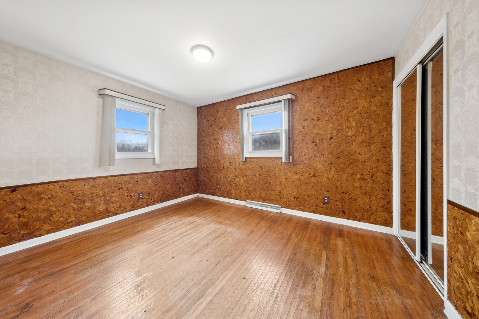 213 South Anderson Road New Lenox, IL 60451 - Photo 17 of 32 a view of an empty room with wooden floor and a window