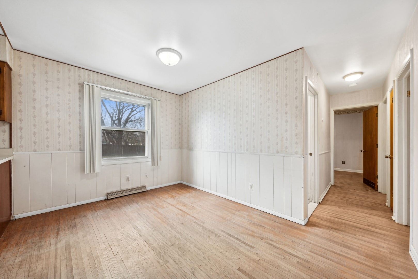 213 South Anderson Road New Lenox, IL 60451 - Photo 9 of 32 a view of an empty room with wooden floor and a window