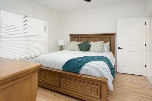 a bedroom with a bed and wooden floor