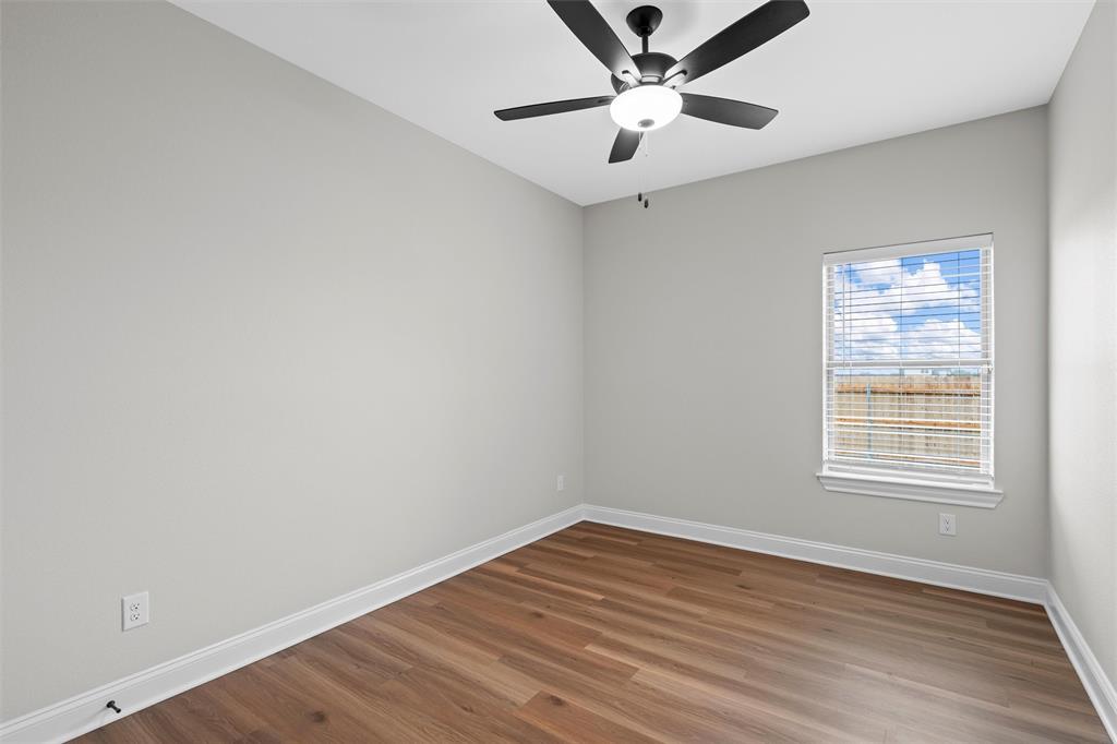 1320 Promised Land Road Hewitt, TX 76643 - Photo 14 of 26 an empty room with a window and a ceiling fan
