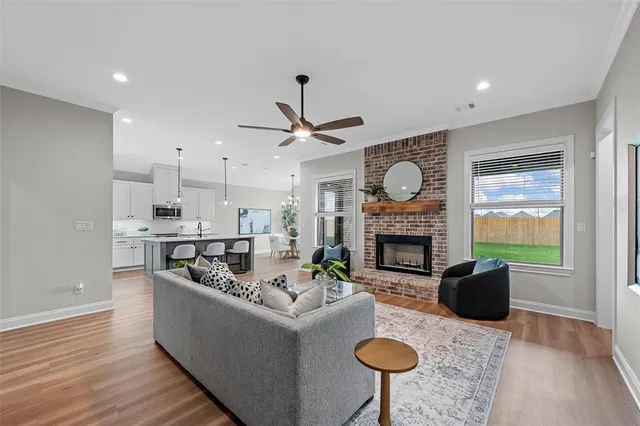 a living room with furniture a fireplace and a window