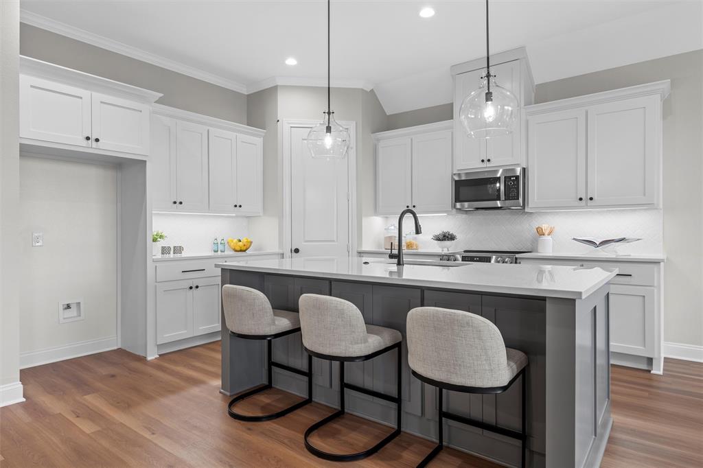 1320 Promised Land Road Hewitt, TX 76643 - Photo 6 of 26 a kitchen with kitchen island granite countertop a sink cabinets and wooden floor