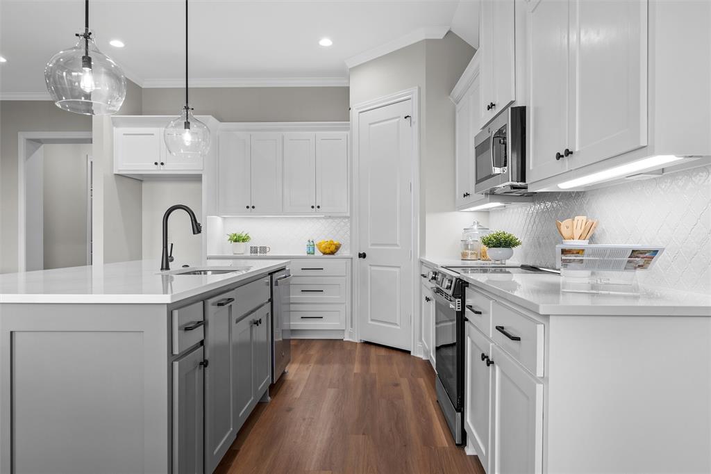 1320 Promised Land Road Hewitt, TX 76643 - Photo 7 of 26 a kitchen with kitchen island granite countertop a sink stainless steel appliances and cabinets